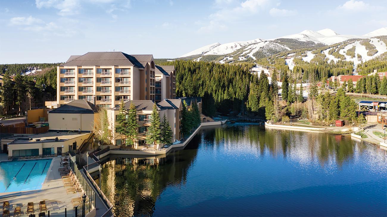 Aerial view of lake at Marriott's Mountain Valley Lodge timeshare location showing snow-capped mountains in background